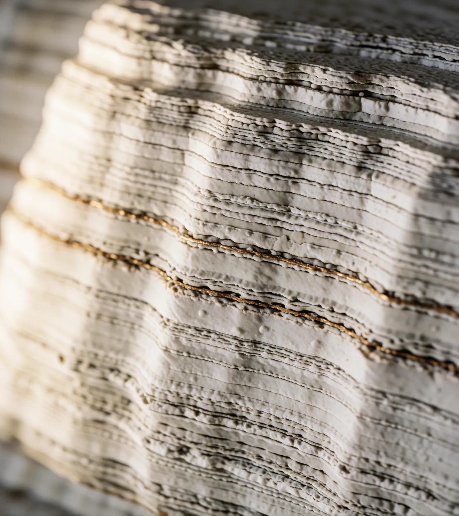 Macro photograph of layered limestone strata with a thin copper vein